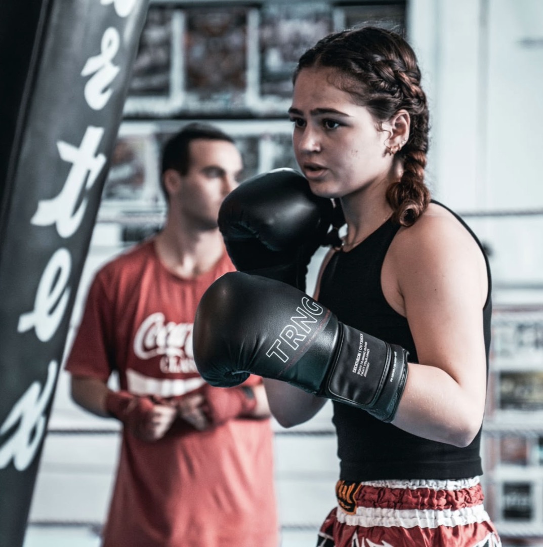 Female fighter in boxing guard with TRNG gloves