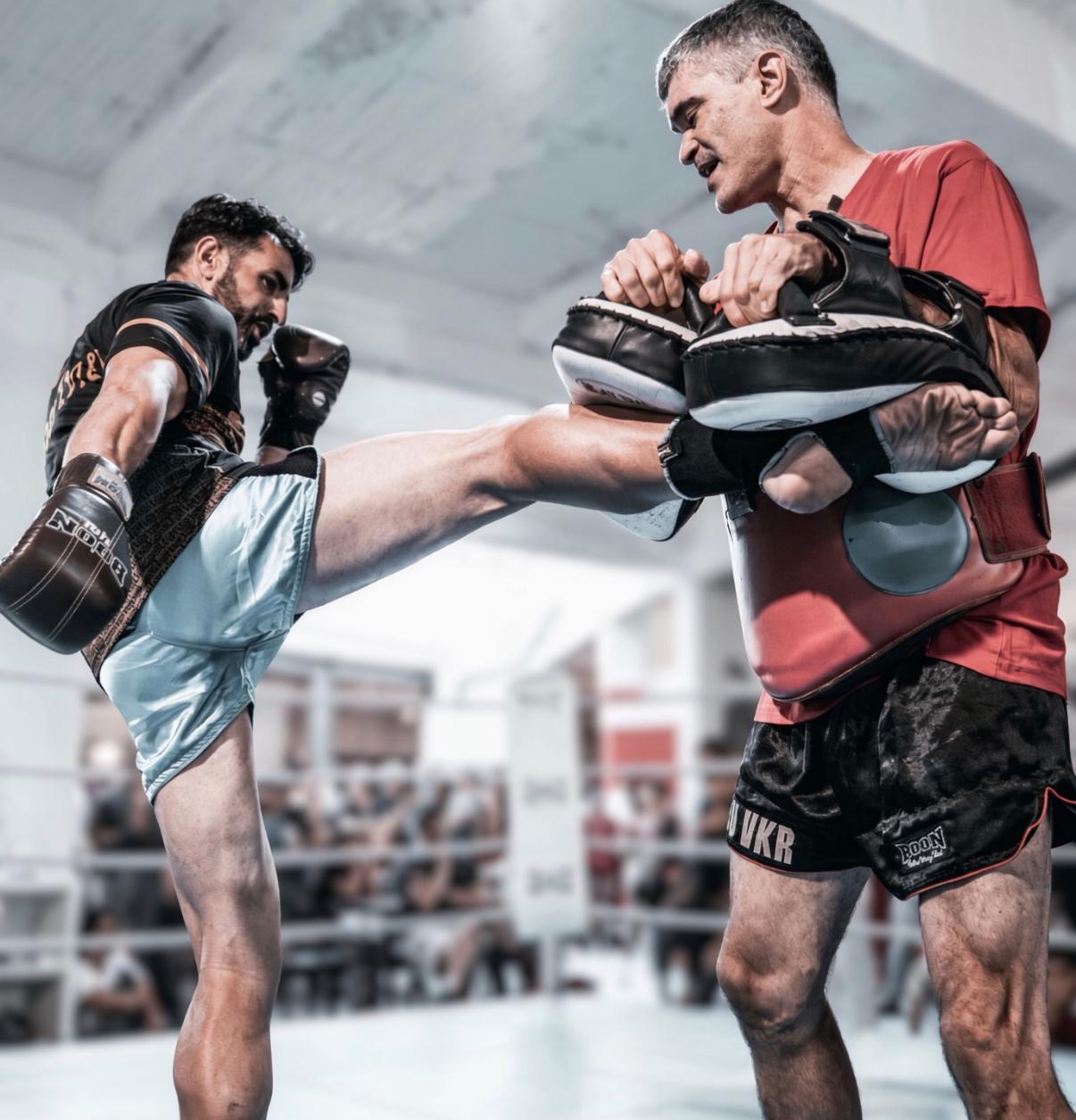 Kicking the pads with coach in the ring